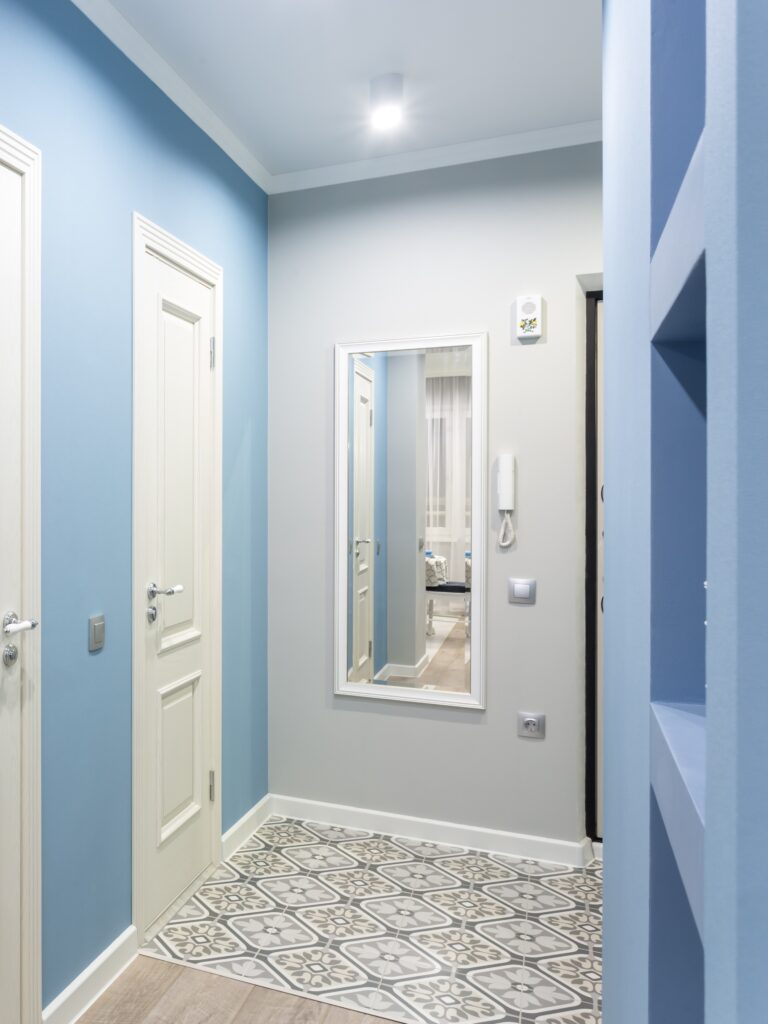 door in modern entrance hall of corridor in blue light color in expensive apartments